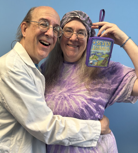 Andy and Kristen, with Kristen holding up a game called Seven Islands.