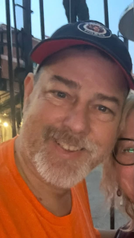 A cropped photo of Paul, smiling, next to his wife.